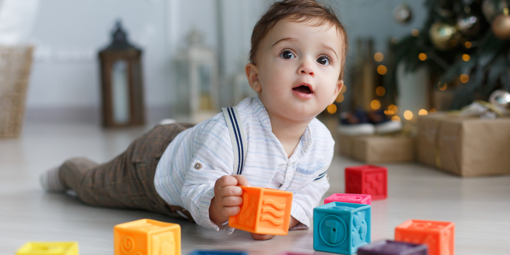 3-6 month old child playing with blocks